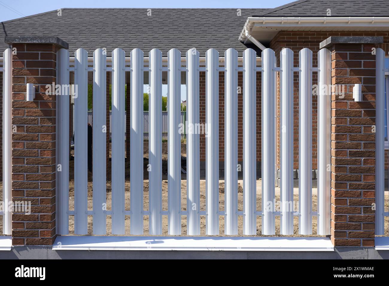 Modern white picket fence at a residential house Stock Photo Alamy