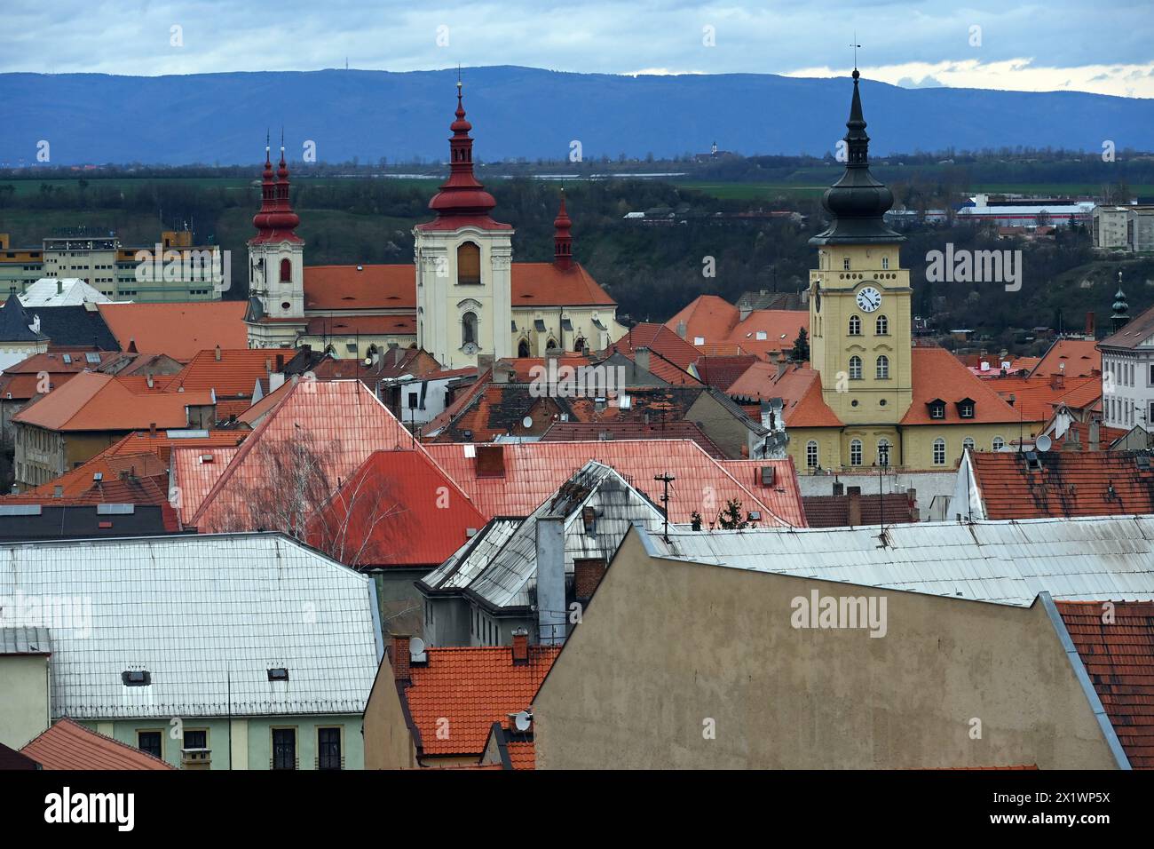 Zatec, Czech Republic. 28th Mar, 2024. FILE PHOTO Church of the assumption of the Virgin Mary and the historic town hall, Zatec, Louny region, Czech Republic, March 28, 2024. Zatec, whose hops landscape became a UNESCO World Heritage Site last year, has won the title the Czech historical town of 2023. Credit: Slavomir Kubes/CTK Photo/Alamy Live News Stock Photo