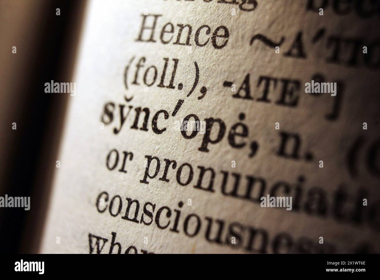 Word syncope on dictionary page, macro close-up Stock Photo