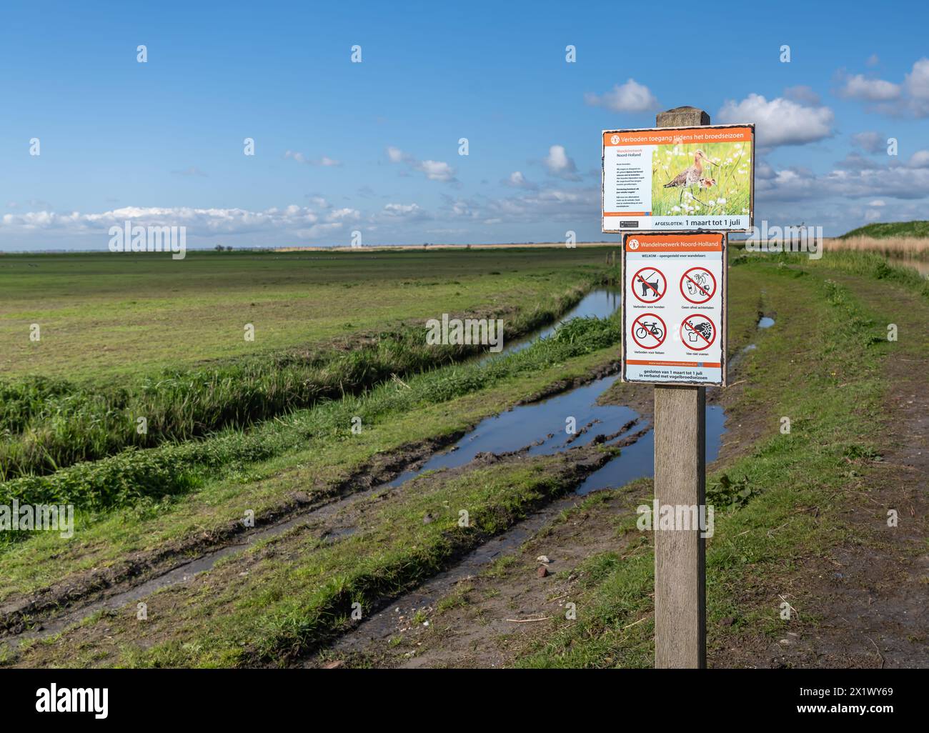 Temporary no entry sign on the side of a dirt road by nature reserve bird sanctuary, prohibited access during the breeding season in the Netherlands Stock Photo