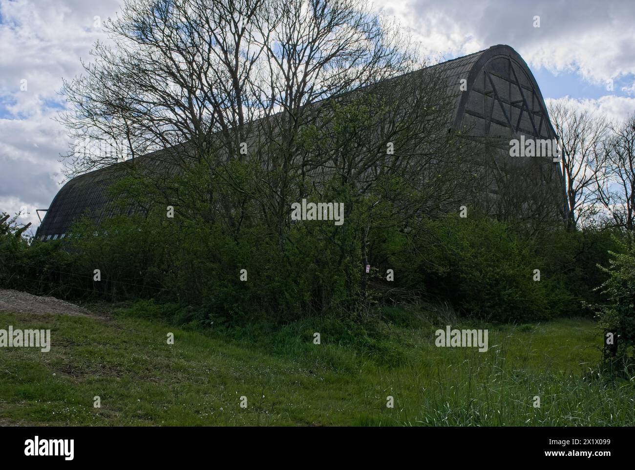 Ecausseville, France - Apr 18, 2024: First wooden hangar built between January and August 1917, when it hosted its first airship. Sunny spring day. Se Stock Photo