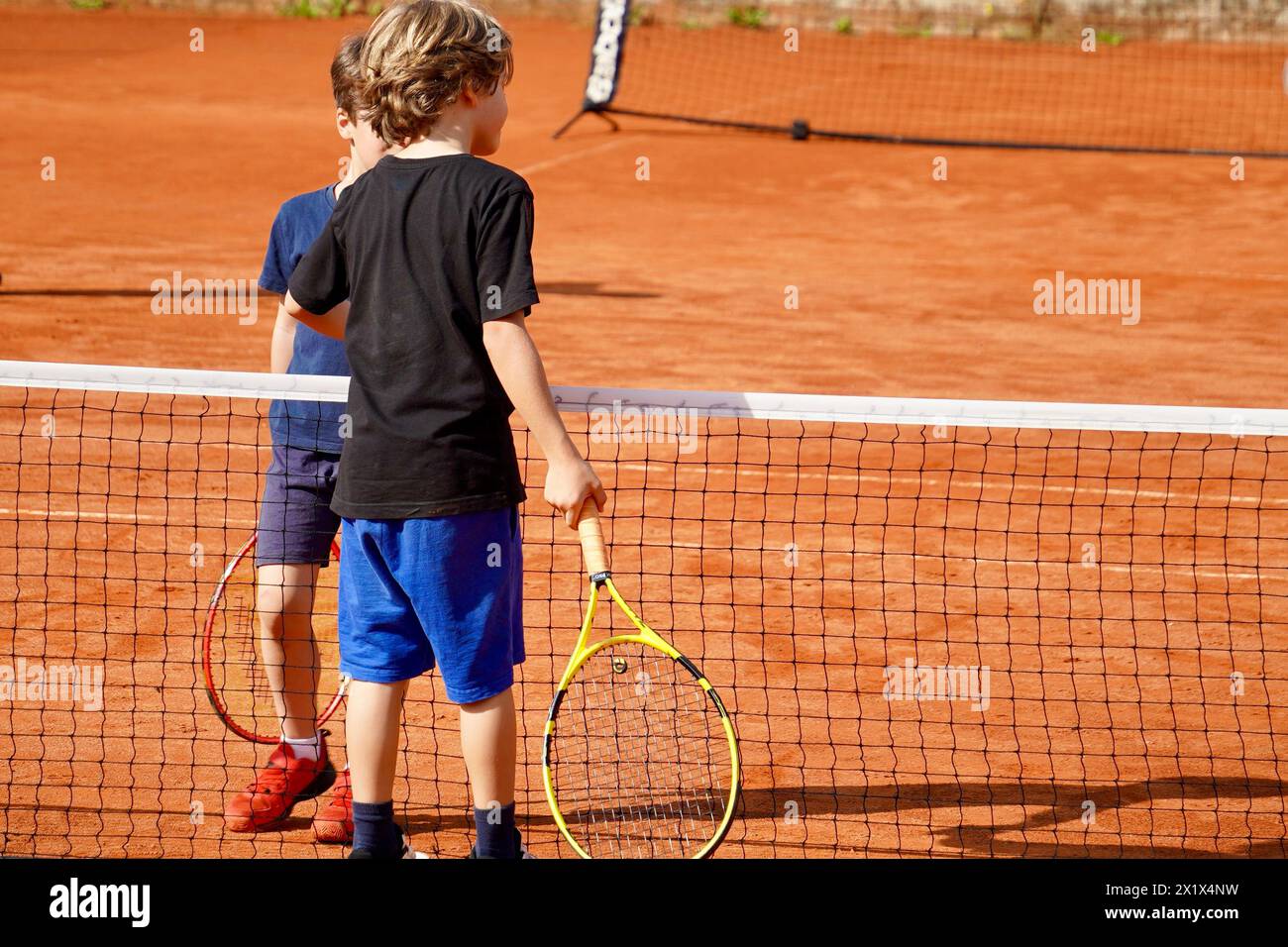 Opponents shake hands after their tennis match game, display of