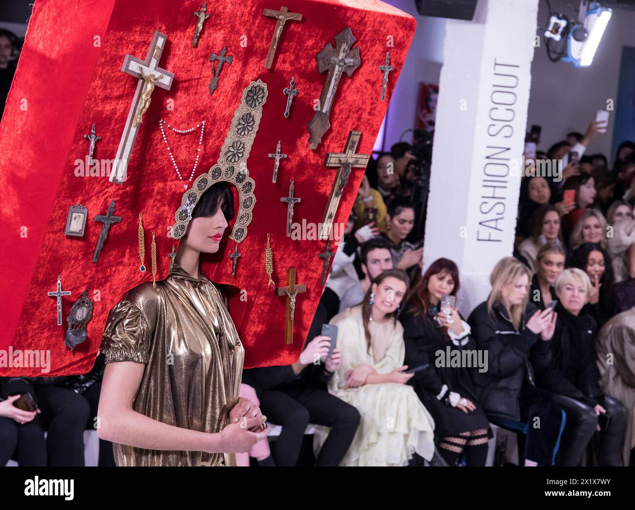 Pam Hogg fashion show during London fashion week crazy head piece red maximalism faith cross Stock Photo