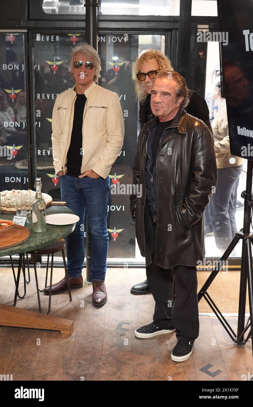 Jon Bon Jovi, David Bryan, and Tico Torres of American rock band Bon Jovi with fans during a pizza party and listening event for their new album 'Forever' in central London. Fans invited to the listening event for the album, which is released on June 7, were surprised when their music idols joined the London gathering. Picture date: Thursday April 18, 2024. Stock Photo