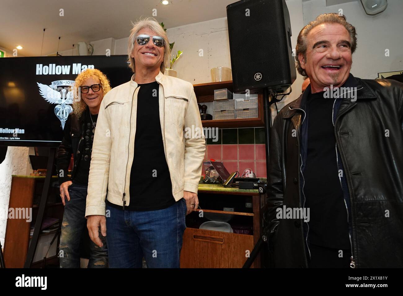 David Bryan, Jon Bon Jovi, and Tico Torres of American rock band Bon Jovi with fans during a pizza party and listening event for their new album 'Forever' in central London. Fans invited to the listening event for the album, which is released on June 7, were surprised when their music idols joined the London gathering. Picture date: Thursday April 18, 2024. Stock Photo