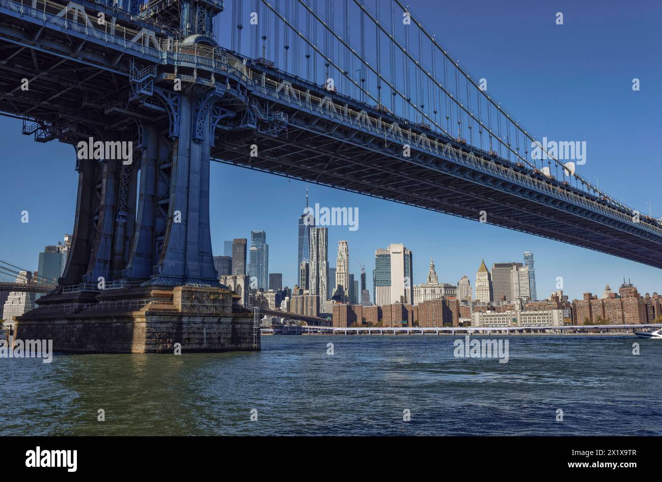 Lower Manhattan skyscrapers behind East River and Brooklyn Bridge seen from Main Street Park, Brooklyn,  New York Stock Photo