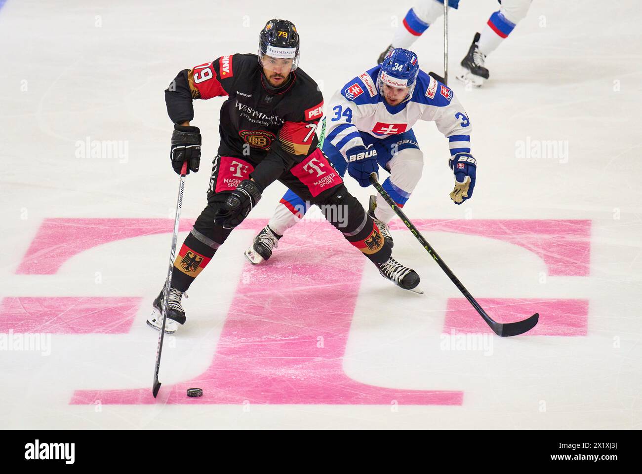 Colin Ugbekile Nr.79 of Germany compete, fight for the puck against, in the match GERMANY - SLOVAKIA  Friendly match DEB ICE HOCKEY, World Championship 2024 preparation in Kaufbeuren Germany, Apr 18, 2024,  Season 2023/2024, Slowakei,  Photographer: ddp images / star-images Stock Photo