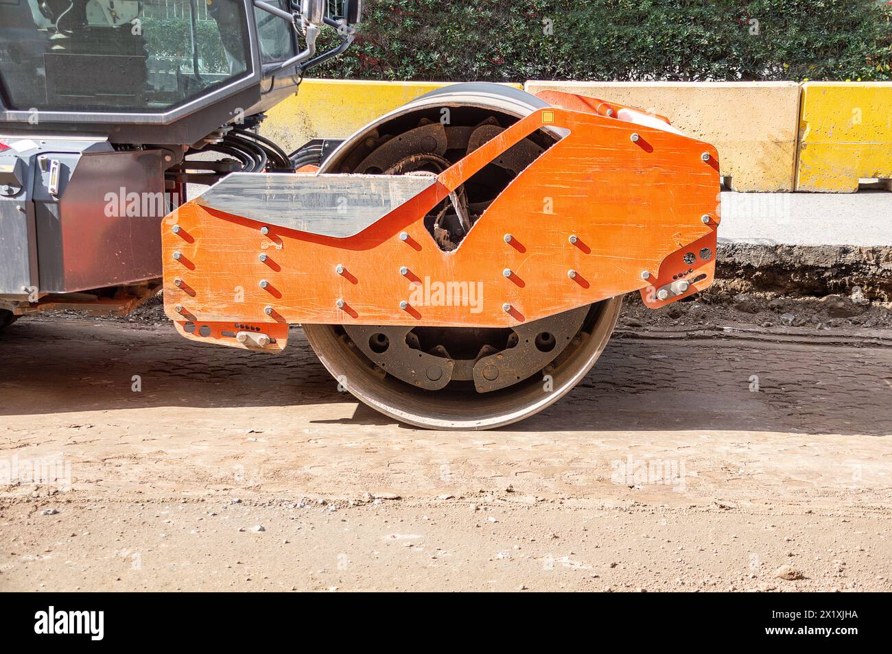 Front view eye catching yellow road roller with enclosed climate