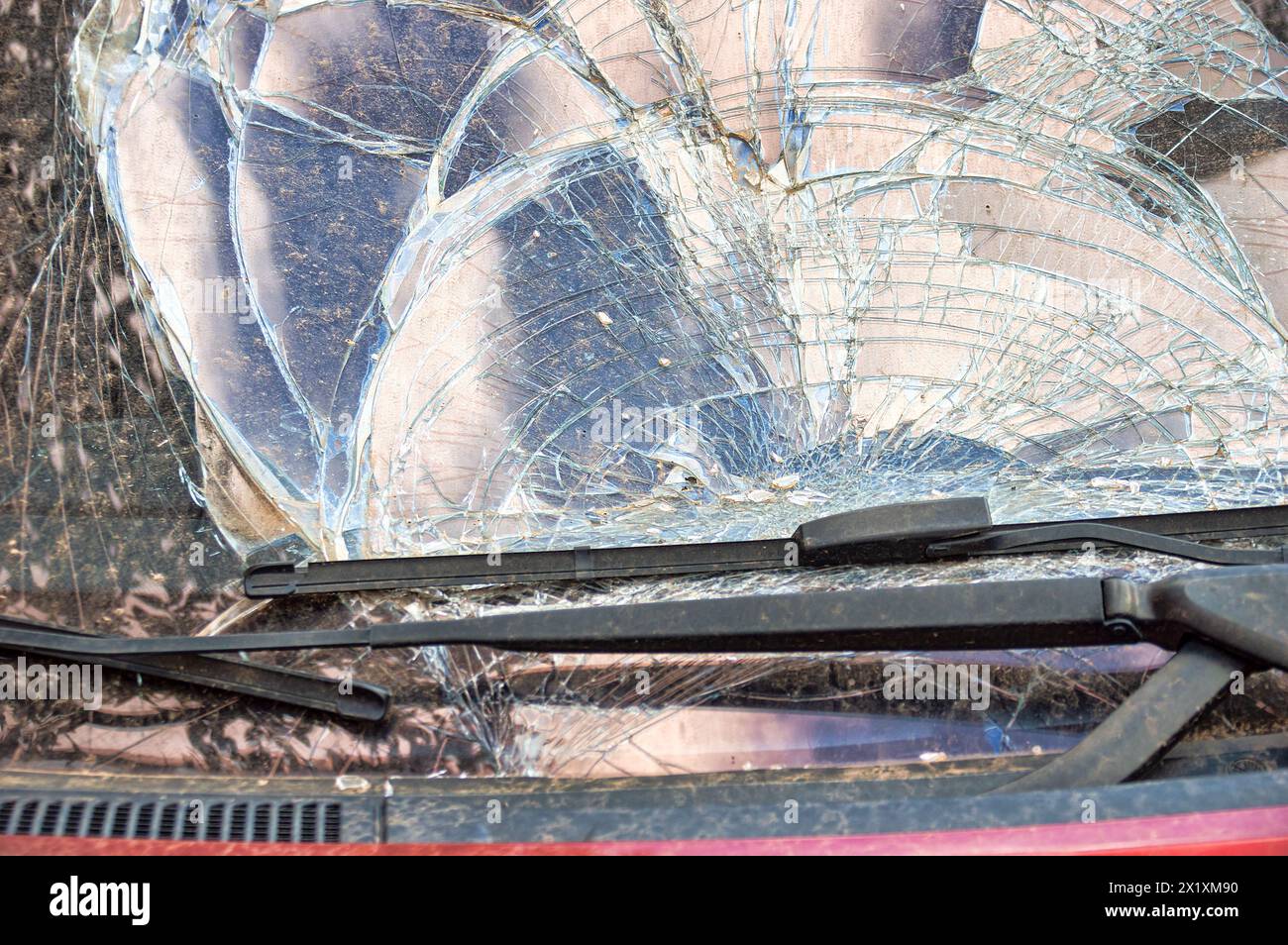 Detail of damage to windscreen of car shattered by vandalism Stock Photo
