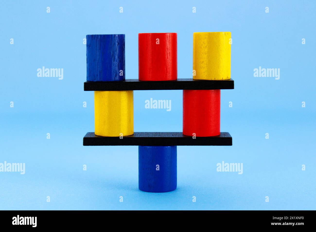 Cylinders balanced on a support point Stock Photo