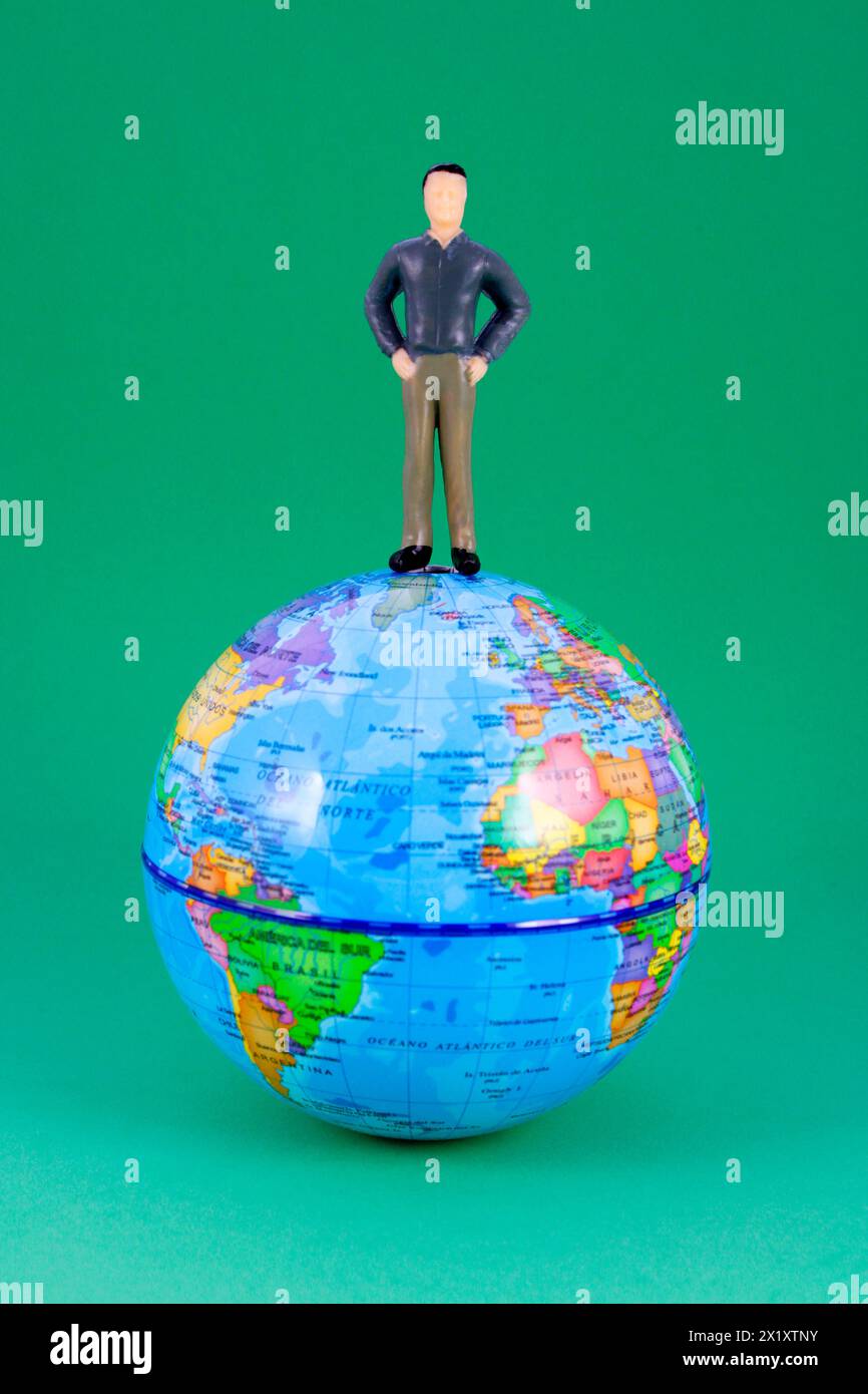 Man on planet earth sphere (plastic human figure, map in Spanish) Stock Photo