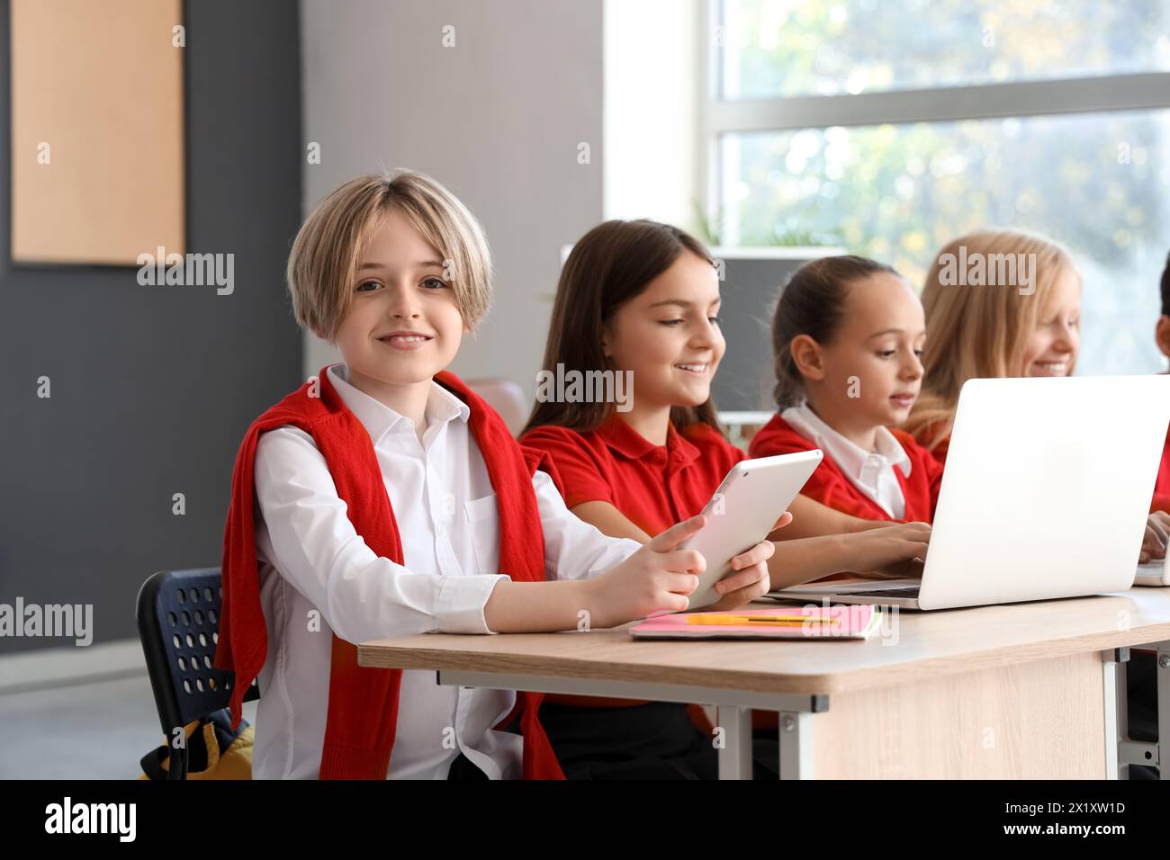 Little boy studying with tablet at school computer lab Stock Photo - Alamy