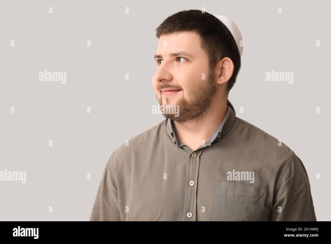 Young Jewish man in hat on light background Stock Photo