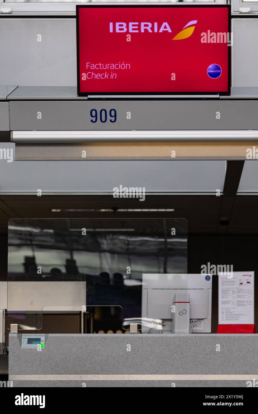 Frankfurt International Airport, Germany - February 19, 2024: displays with advertisement for the Frankfurt Airport hanging above empty check-in count Stock Photo