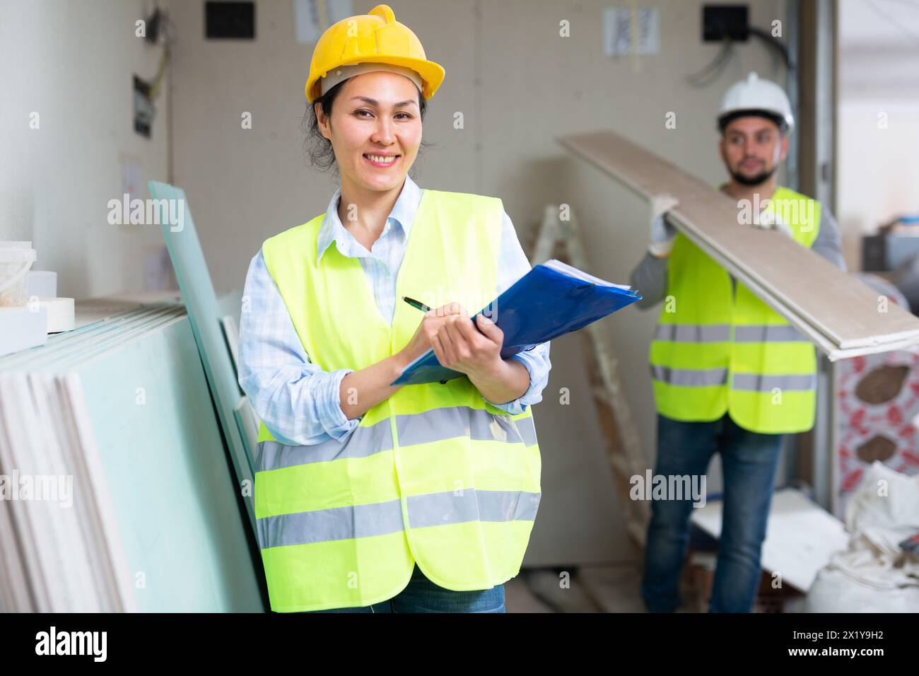 Smiling female civil engineer with documents at construction site Stock ...