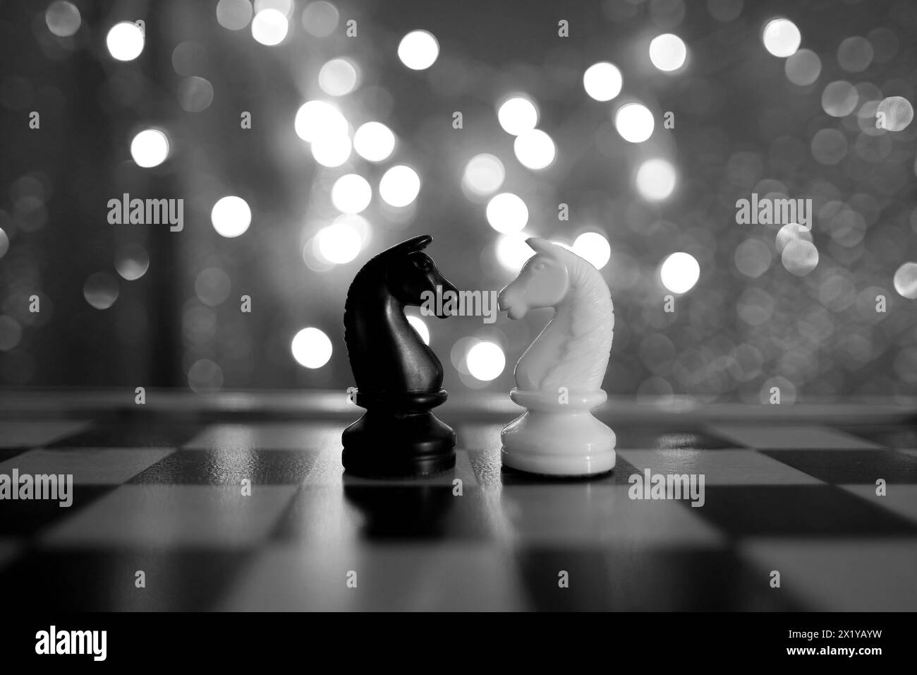 chess pieces, horse, white and black on a chessboard, concept of leadership and teamwork in business, duel, opposition of light and dark forces, sport Stock Photo