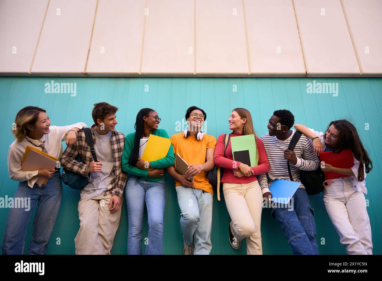 Low angle. Large group multi-ethnic and diverse students smiling looking each other Stock Photo