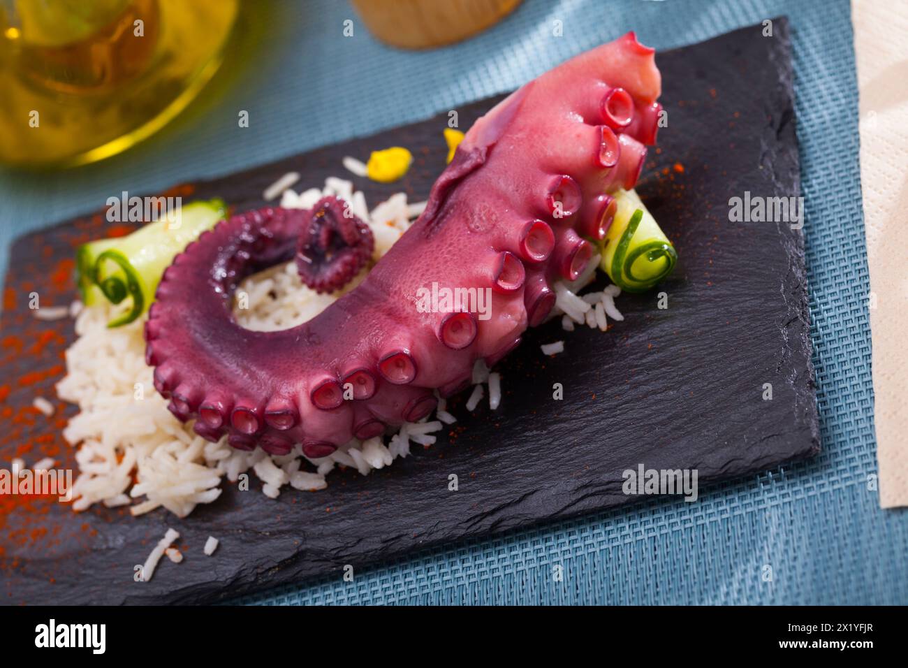 Octopus with rice served with paprika Stock Photo - Alamy