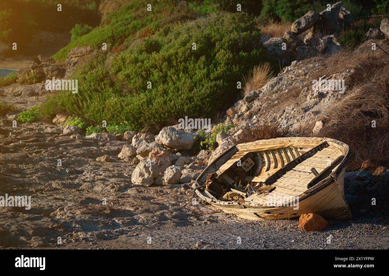 An old wooden boat lies on the seashore Stock Photo - Alamy