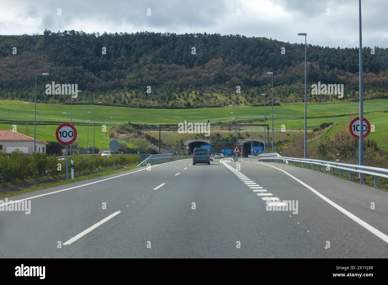 Driving along A-12 highway. Vehicules getting close to Erreniega Tunnel at Sierra del Perdon, Navarre, Spain Stock Photo
