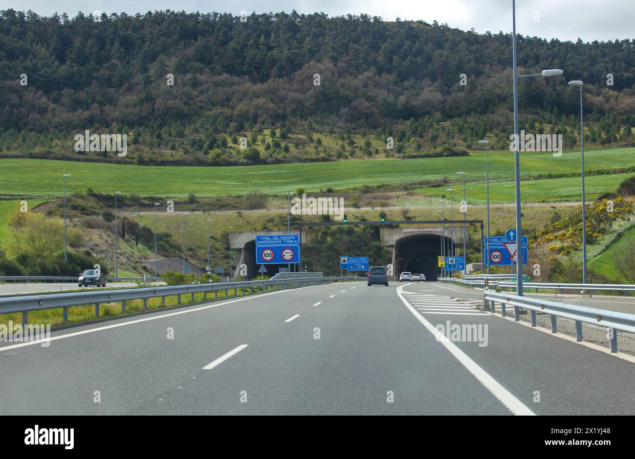 Driving along A-12 highway. Vehicules getting close to Erreniega Tunnel at Sierra del Perdon, Navarre, Spain Stock Photo