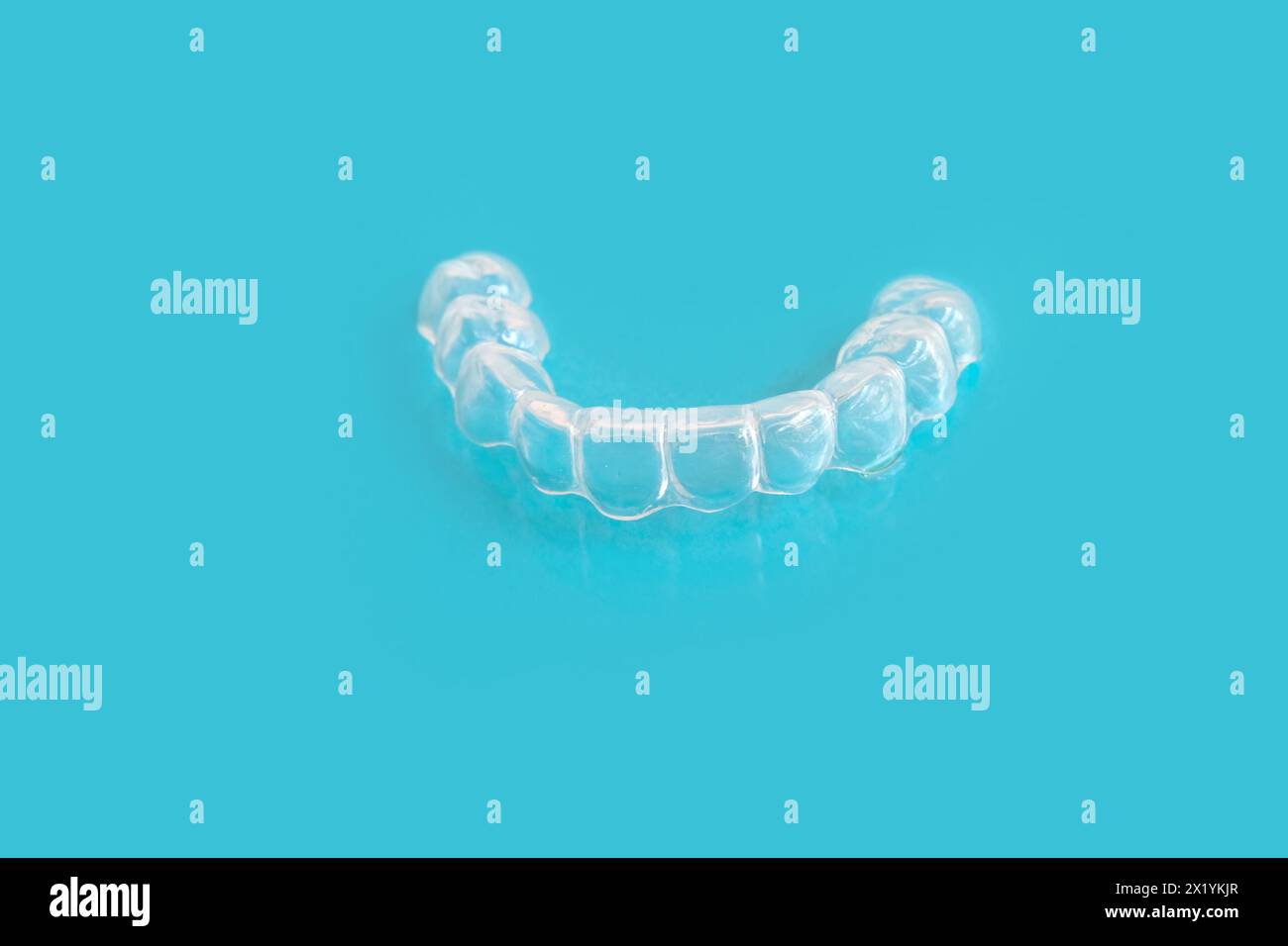 close-up of Silicone Night Mouth Guard for Teeth Clenching Grinding Dental Bite Sleep Aid on a blue background, concept dental services, remedy for gr Stock Photo