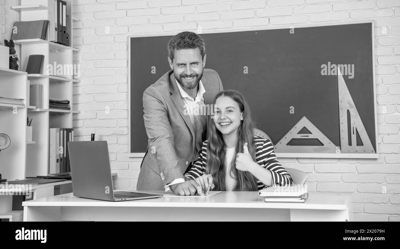 school. positive kid with teacher in classroom use laptop. back to ...