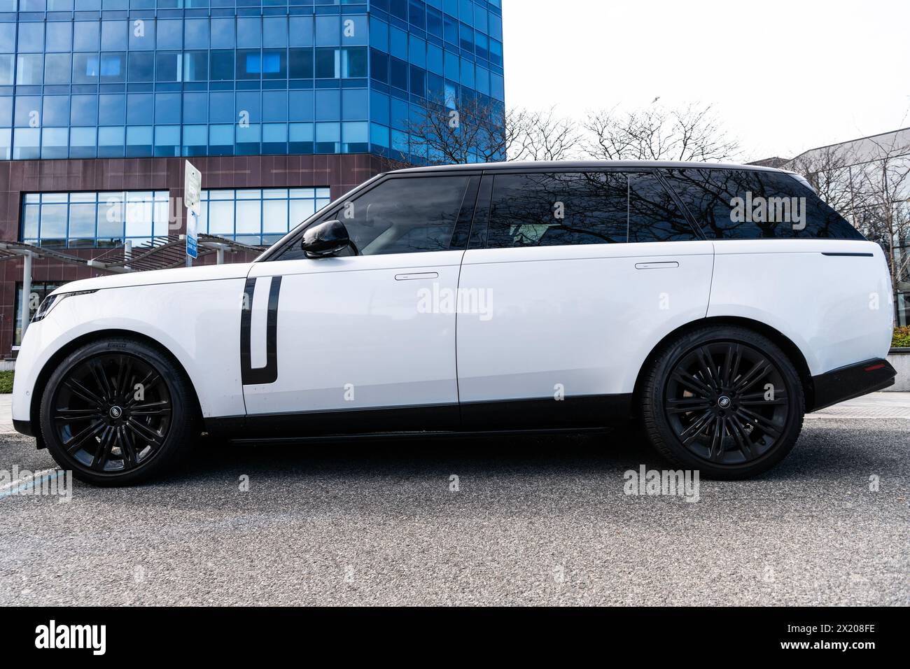 New York City, USA - March 31, 2024: 2024 Land Rover Range Rover Sport SE sportscar white car parked outdoor, side view. Stock Photo