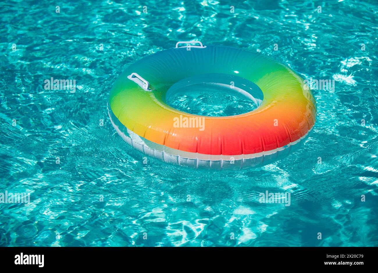 Inflatable rubber ring floating in a blue pool Stock Photo - Alamy
