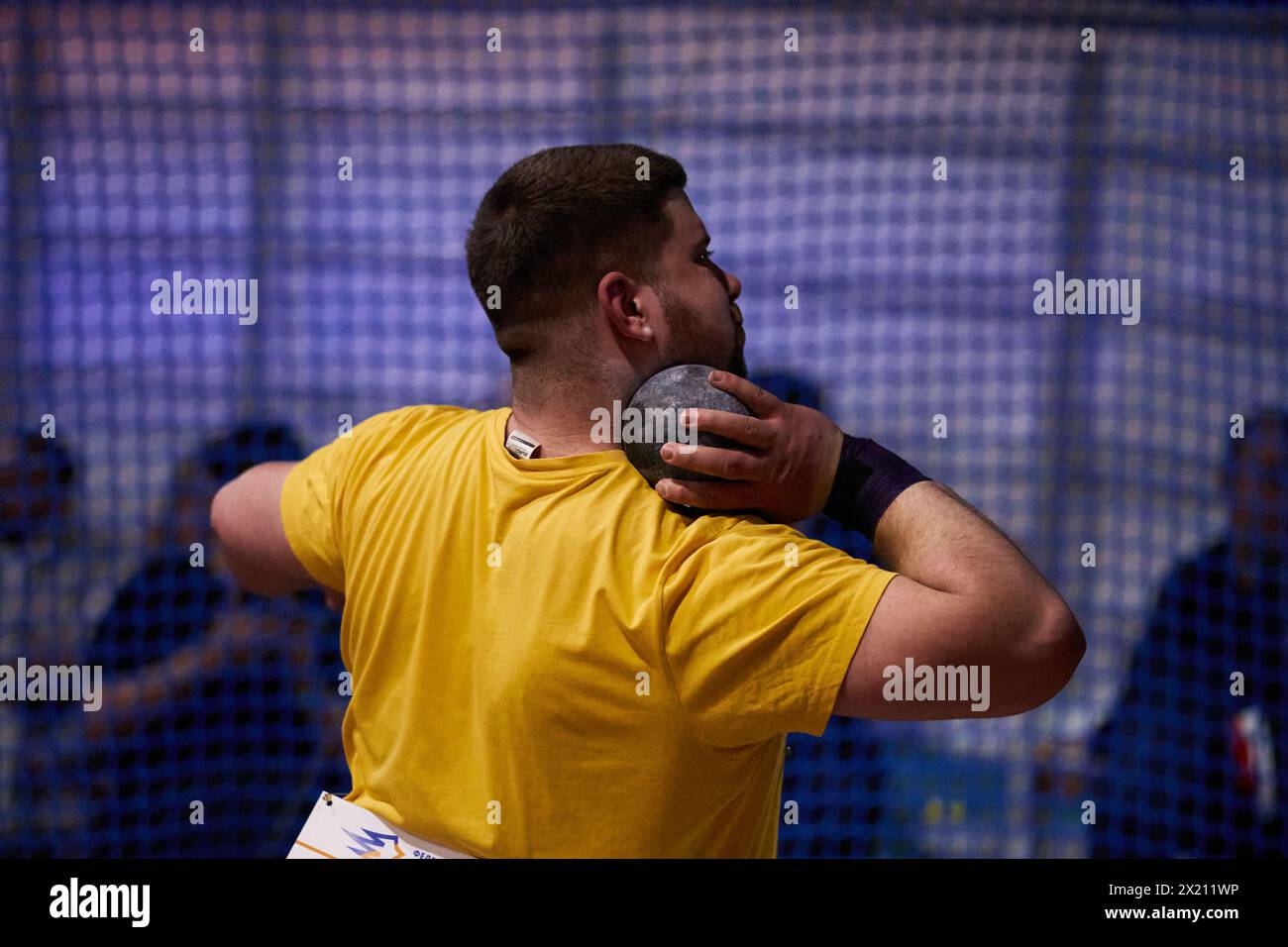 Professional shot putter athlete preparing for a throw. Ukrainian