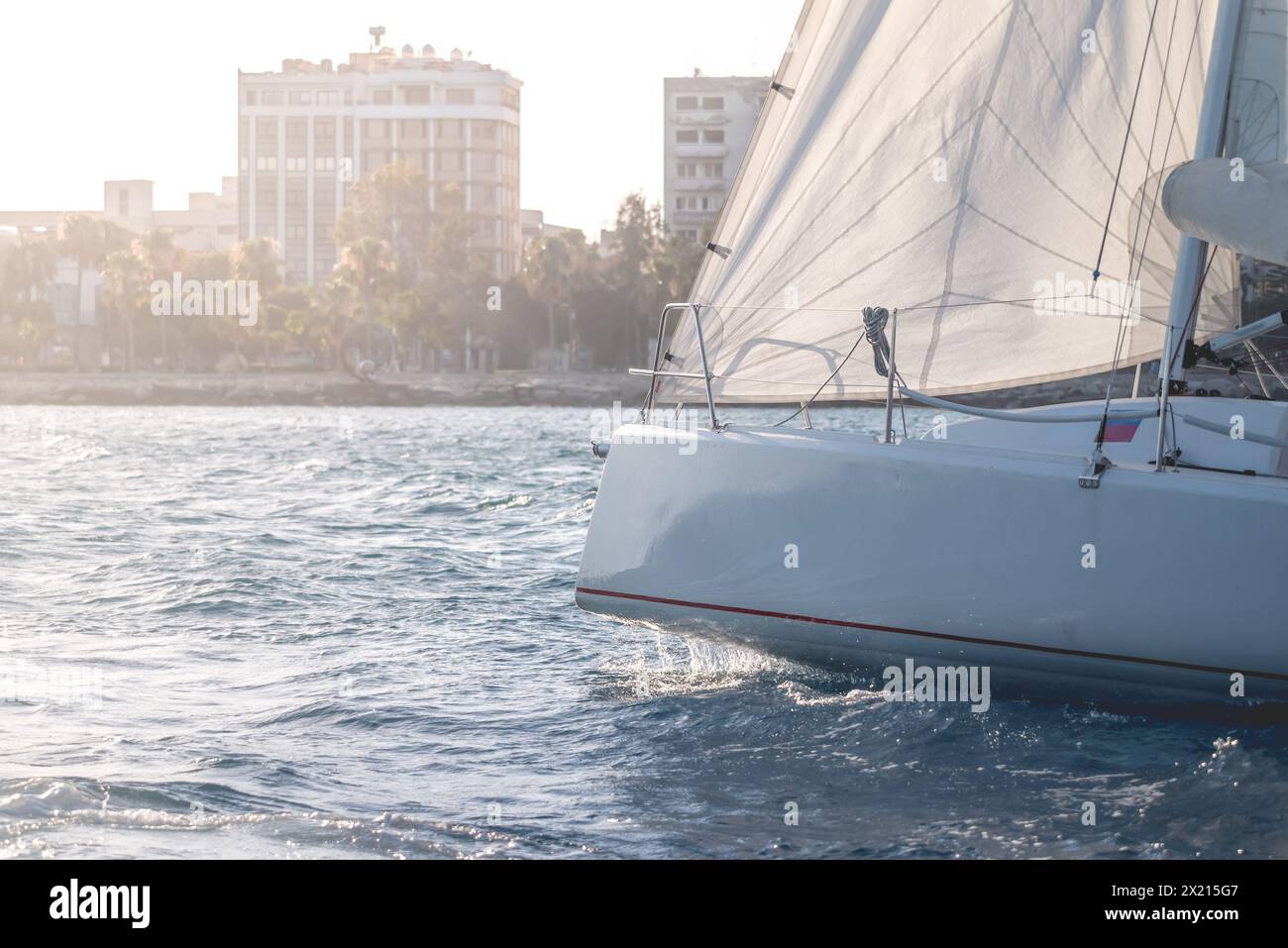 Tranquil and serene sailing at sunset on calm waters with sailboats and nautical navigation. Creating a maritime leisure activity and outdoor adventur Stock Photo