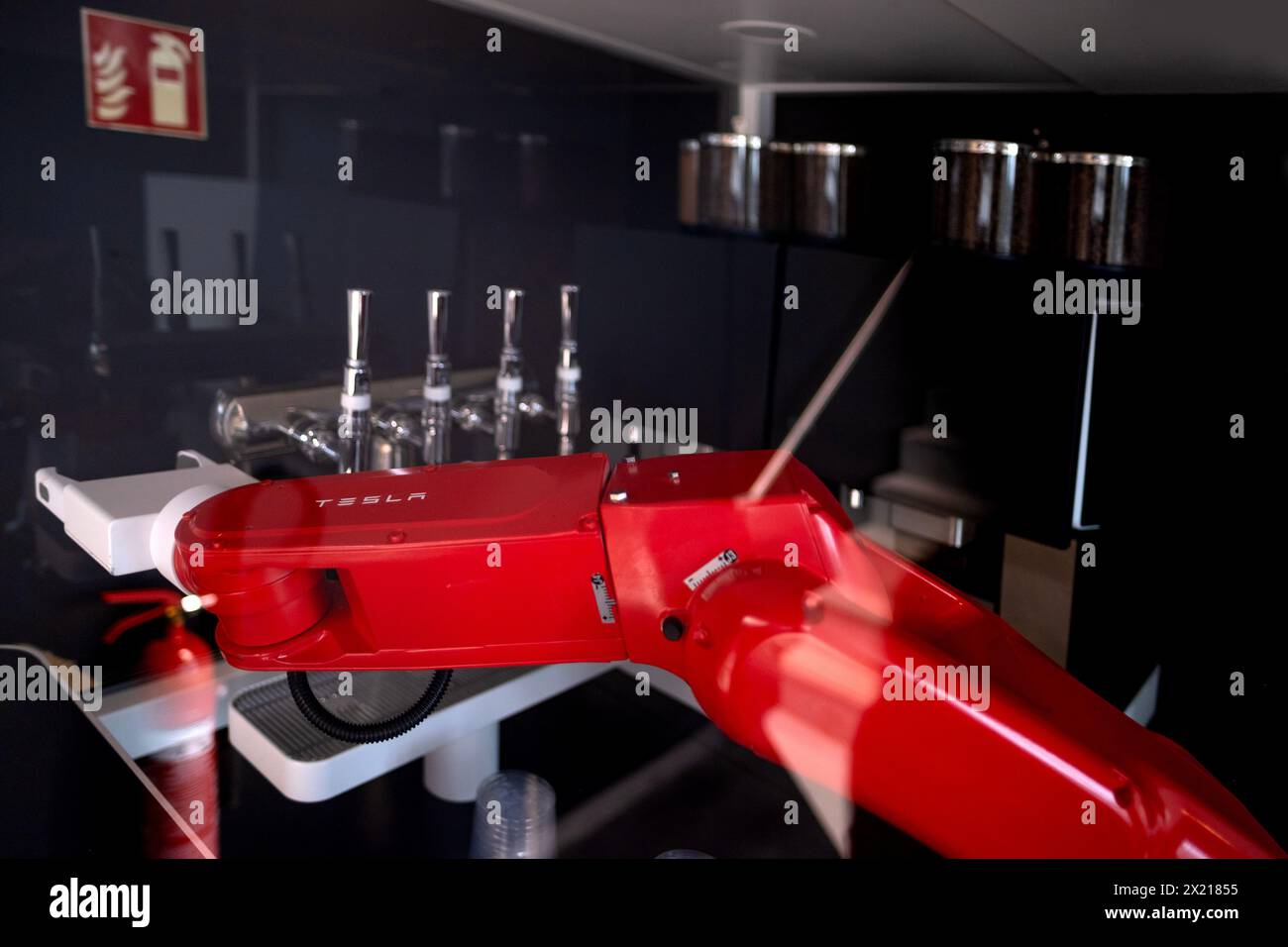 red programmable Tesla robotic mechanical arm with similar functions to human arm in Gigafactory Berlin-Brandenburg Tesla manufacturing location in Eu Stock Photo