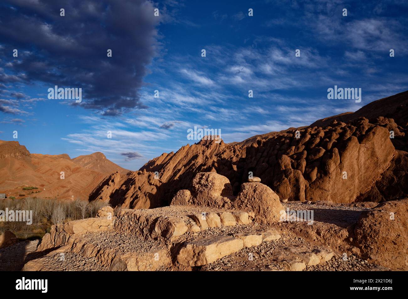 Man crafted mound at a viewpoint of moroccan high atlas mountains under a sky with grey clouds, capturing the serene beauty from a prime viewpoint. Stock Photo