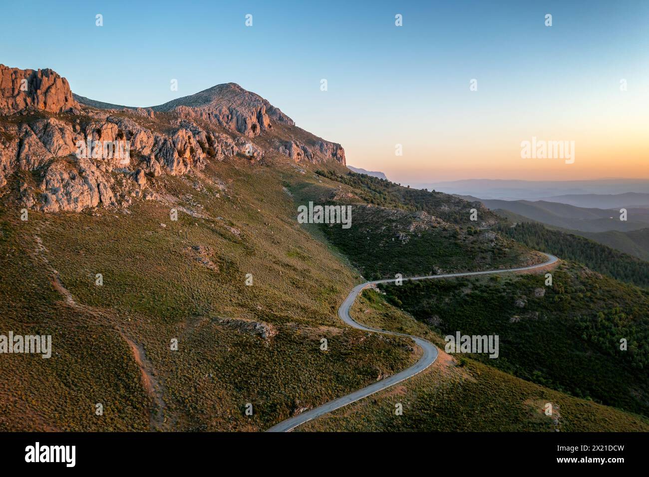 Road on a wild mountain landscape at sunset in Sardinia, Italy Stock Photo