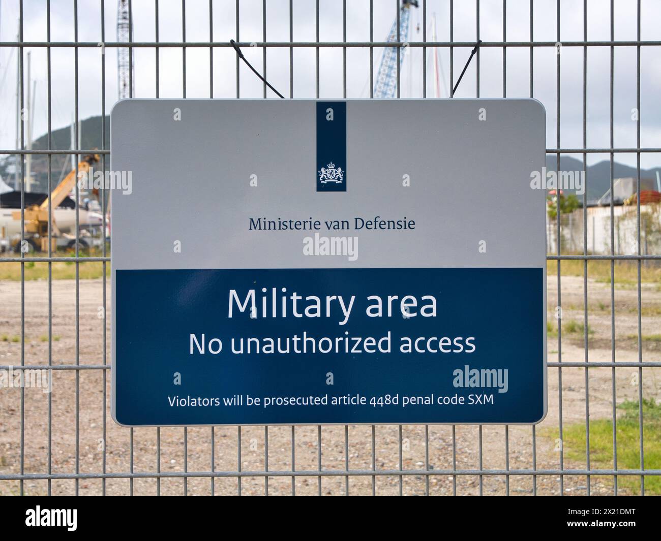 St Maarten - Jan 24 2024: Near the port area in St Maarten, Caribbean a blue and grey metal sign warns of a military area to which there is no access. Stock Photo