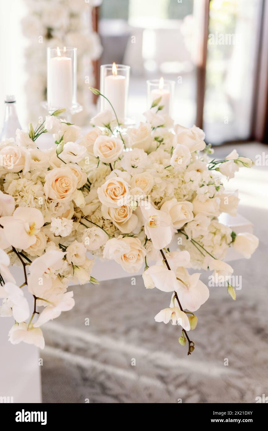 Elegant floral centerpiece with candles for sophisticated event Stock