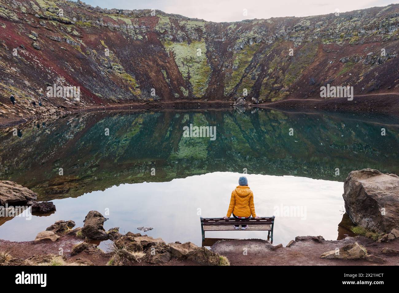Contemplative solitude by a tranquil crater lake in Iceland Stock Photo