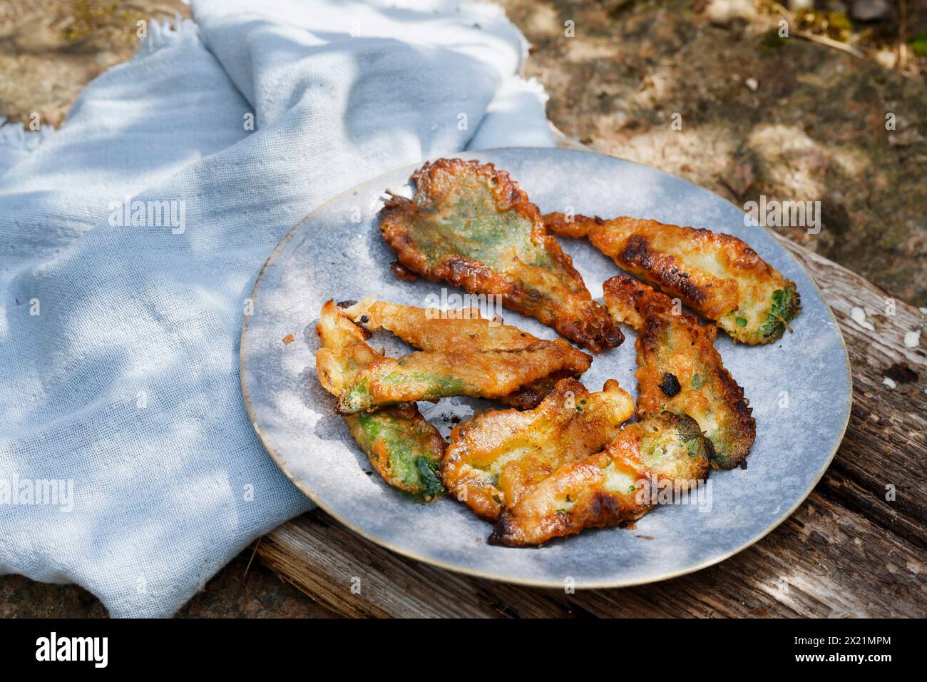 Making vegan plant-based potato chips with nettle leaves, step 5: Finished pastry sheets are arranged on a plate, series image 5/5 Stock Photo