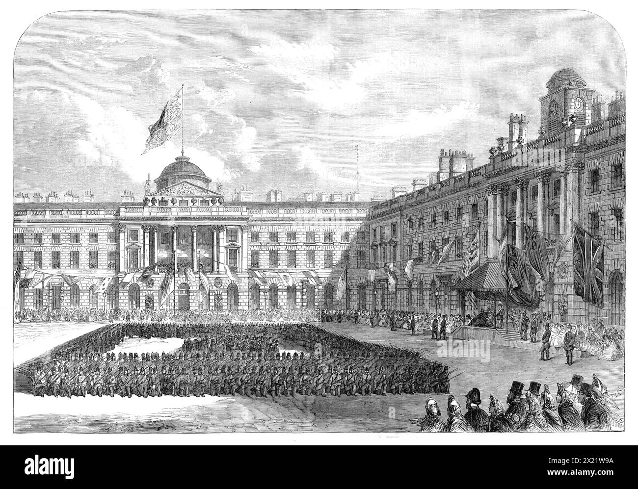 Inspection of Civil Service Volunteers by the Prince of Wales in the Quadrangle of Somerset House, [London], 1864. '...a vast quantity of coloured bunting had been employed in...the decoration of the buildings, and in the fitting up of a beautiful kiosk, with raised dais...[and] seats were arranged, accommodating a large number of spectators. The windows, and even the roofs, of the buildings were also crowded...The field state gave a total of four hundred men, of whom sixty were recruits recently passed into the line...our Artist has sketched their appearance when they had faced to the front, Stock Photo