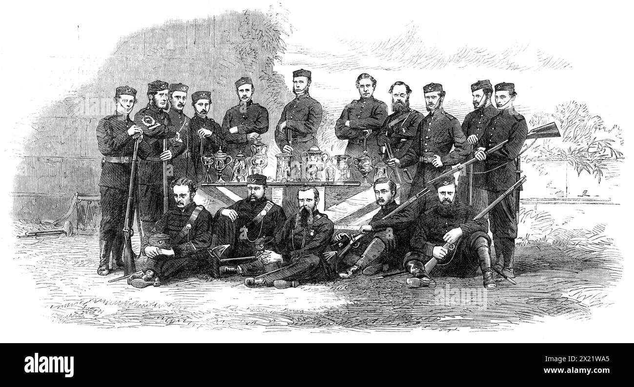 Prizes and Prize-Winners of the Calcutta Volunteer Rifle Matches at Barrackpore, [India], 1865. Participants in '...competitive trials in skill as marksmen...The gentlemen grouped around this table are the successful competitors of the two last annual meetings - namely, Lieutenant J. Mackenzie, Captain M. J. Pearson, Lieutenant Fred. G. Teale, Private E. Lane, and Private J. Morrison, in the front row, sitting; Corporal Fink, Colour-Sergeant G. Robb, Sergeant Humphreys, Private Goebels, Private D. C. Creaton, Sergeant Dods, Sergeant Boggs, Captain John Rose, Sergeant Macdonald, Private Pratt, Stock Photo