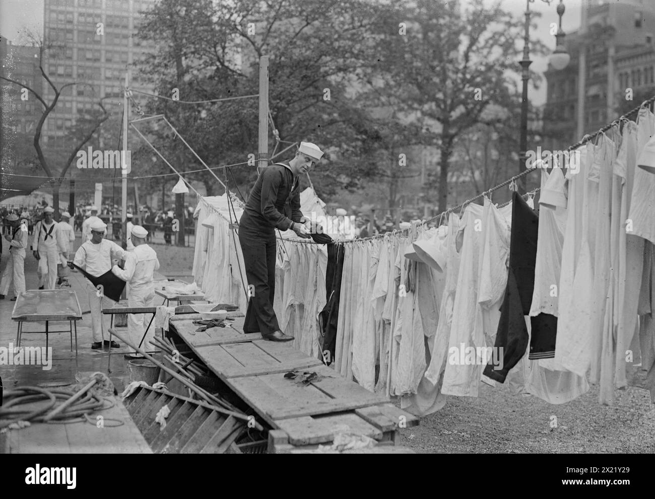W.J. Reilly, unknown date. William J. Reilly, sergeant in the Navy and vaudeville performer, who recorded patriotic songs as &quot;Sailor Reilly&quot;. He is hanging laundry on the grounds of the USS Recruit, a wooden mockup of a battleship built in Union Square, New York City by the Navy to recruit seamen and sell Liberty Bonds during World War I. Stock Photo