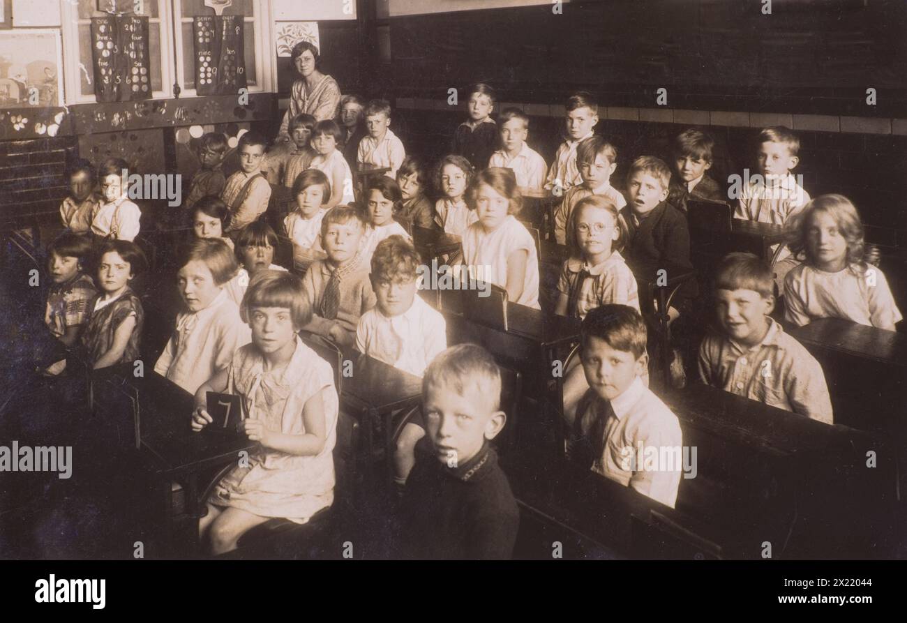 Class seven in their classroom at Burgess Hill Junction Road School with teacher in background in 1936 Stock Photo