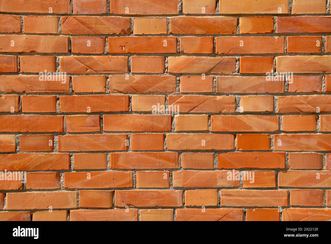 exposed brick wall, construction detail of a wall with decorative elements given by the simple rhythm of the texture, joint between exposed bricks on Stock Photo