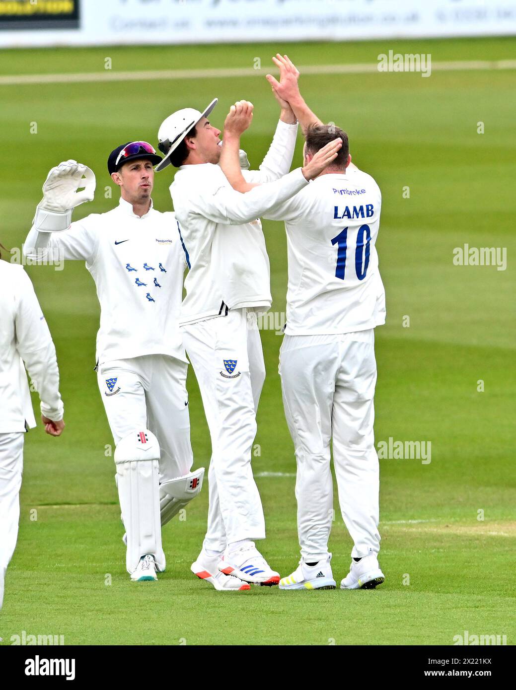 Hove UK 19th April 2024 - Sussex bowler Danny Lamb accidentally slaps fielder James Coles in the face as they celebrate after Lamb had taken the wicket of Gloucestershire's Cameron Bancroft LBW for 27 runs  during the Vitality County Championship League Two cricket match at the 1st Central County Ground in Hove : Credit Simon Dack /TPI/ Alamy Live News Stock Photo