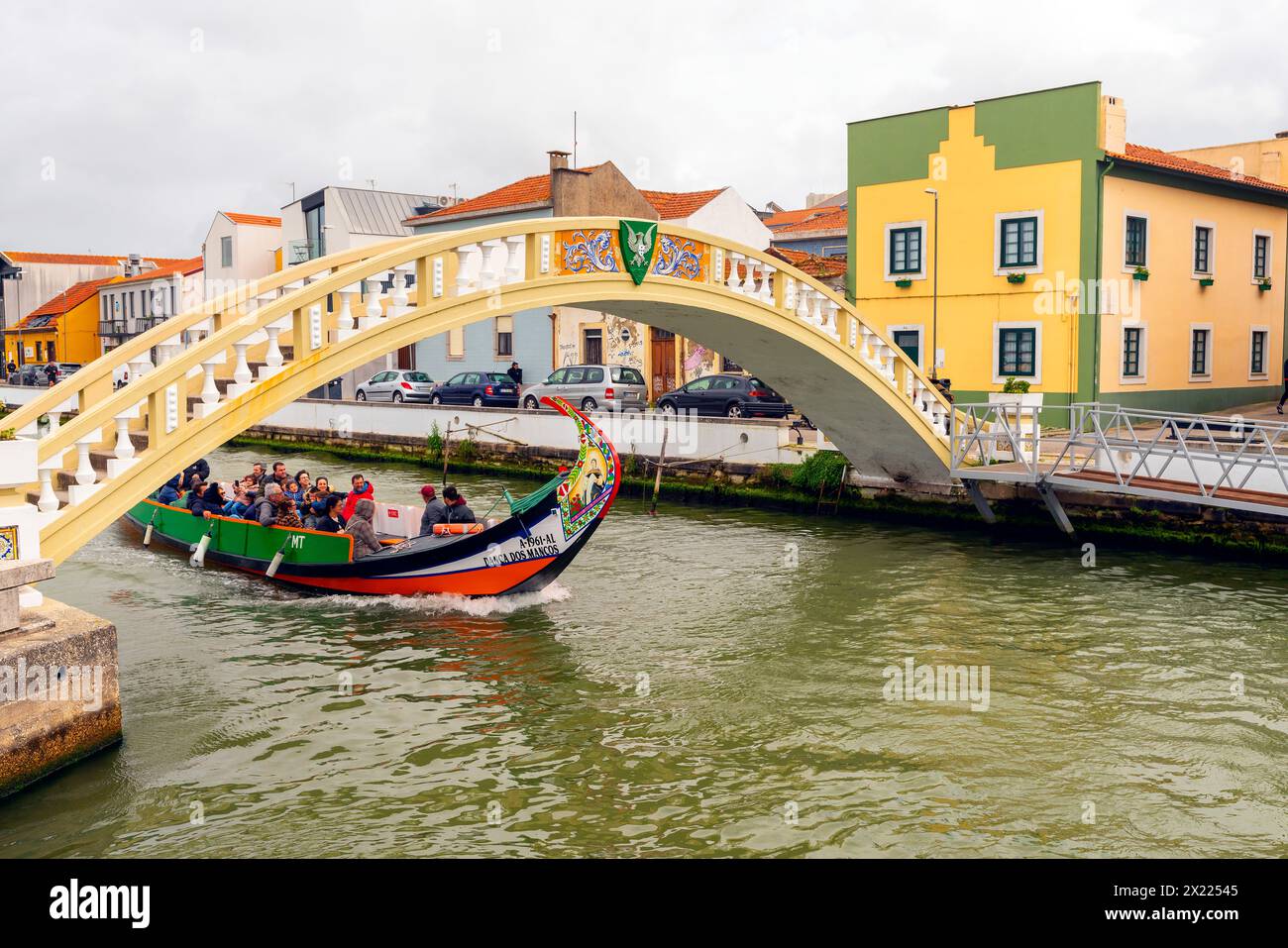 Tourists on a boat sailing through the Central Canal. Colorful houses ...