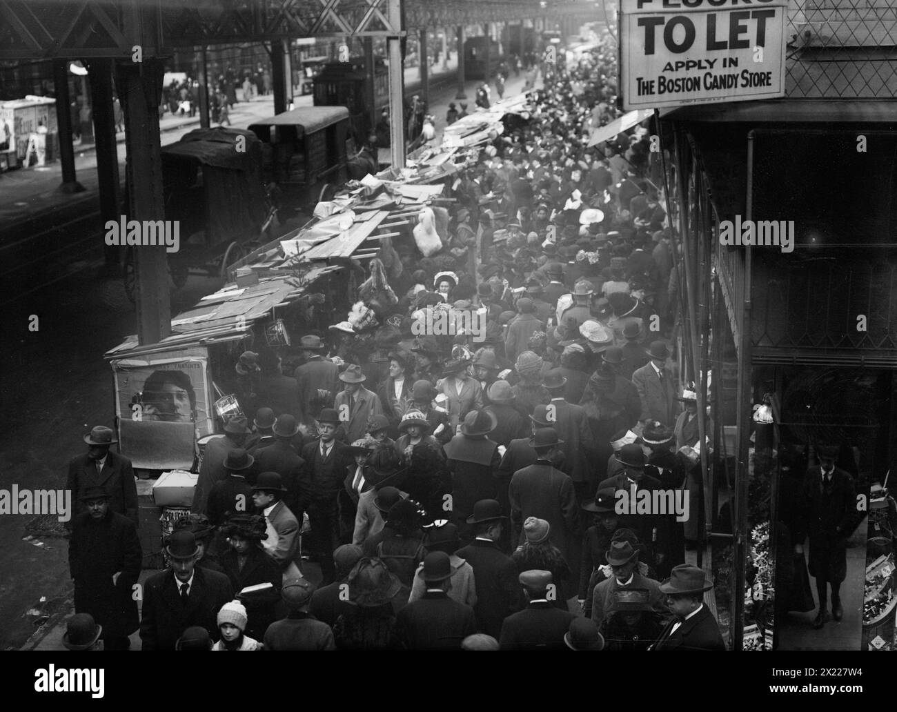 Crowded street, possibly near a subway station, between c1910 and c1915. Stock Photo