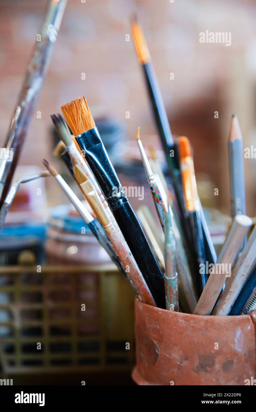 Different brushes in drawing studio interior. Close up view , vertical shot Stock Photo