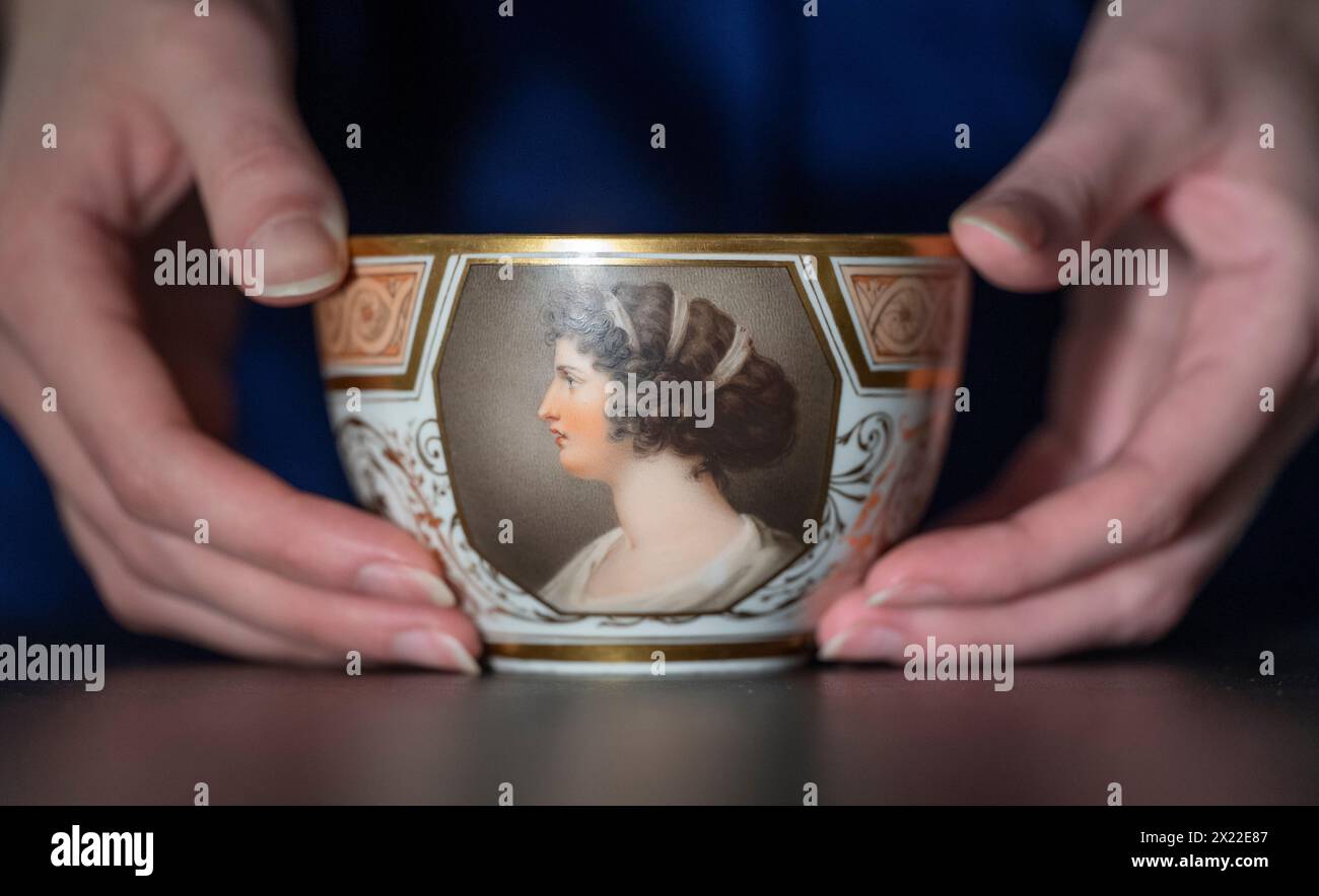 Bonhams, Knightsbridge, London, UK. 19th Apr, 2024. Nelson Forever! A Naval Legacy in Ceramics and Glass, sale on 23 April. Highlights include: Nelson and Emma cup and saucer by Thomas Baxter, dated 1804, estimate £15,000-25,000. Credit: Malcolm Park/Alamy Live News Stock Photo