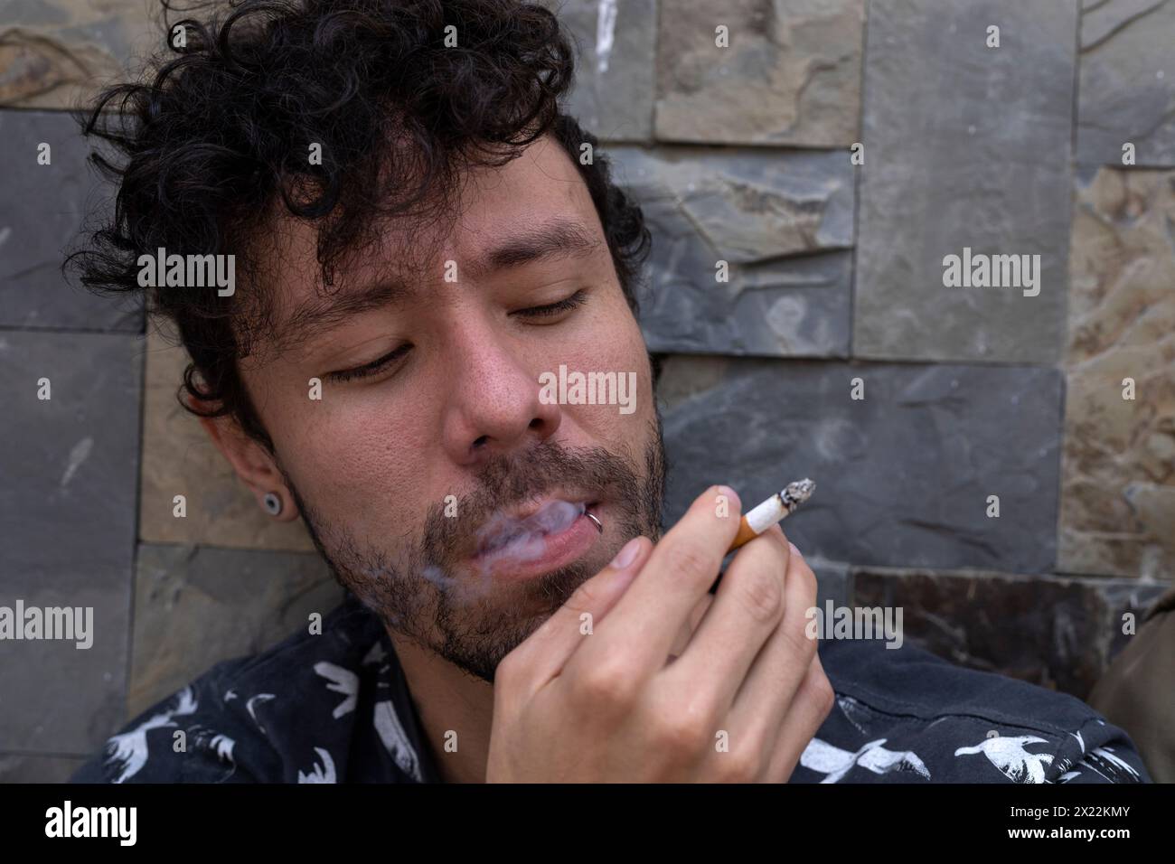 Holding a cigarette in his mouth hi-res stock photography and images
