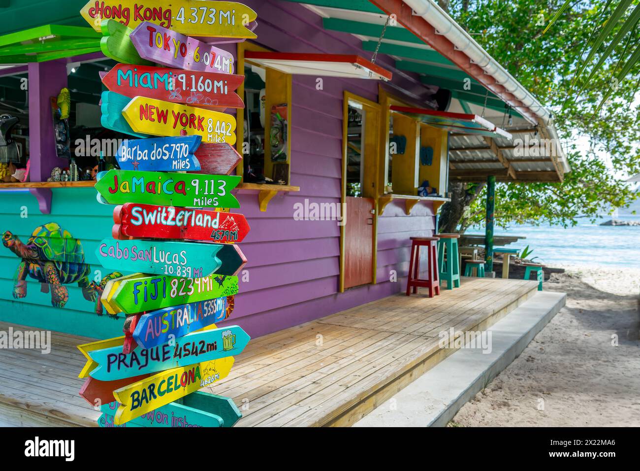 Colorful wooden travel direction signs, bear bar in La DIgue island, Seychelles Stock Photo